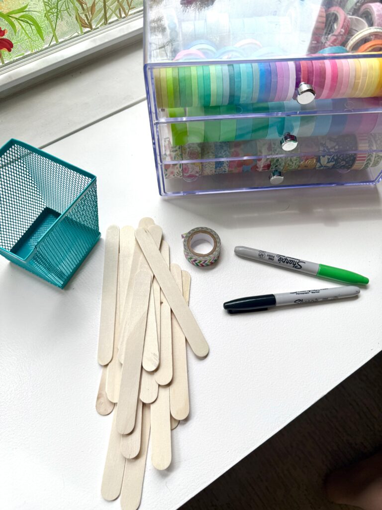 popsicle sticks, sharpies, and washi tape for creating name sticks in a classroom